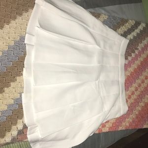 This is a white high rise mini skater skirt